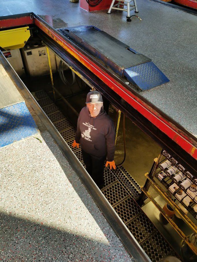 Ashley working in a Grease Monkey pit during the Ninja for a Day contest